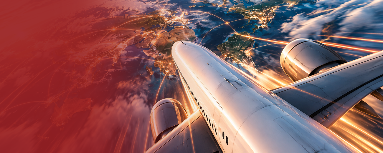 Aeroplane flying over a lit world map for Trackon international shipping