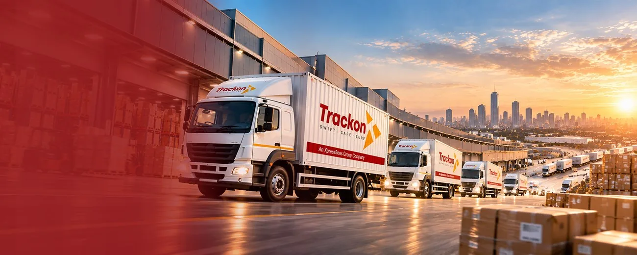 Trackon trucks lined up at a logistics hub at sunset