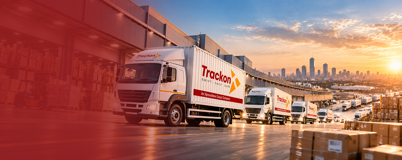 Trackon trucks lined up at a logistics hub at sunset